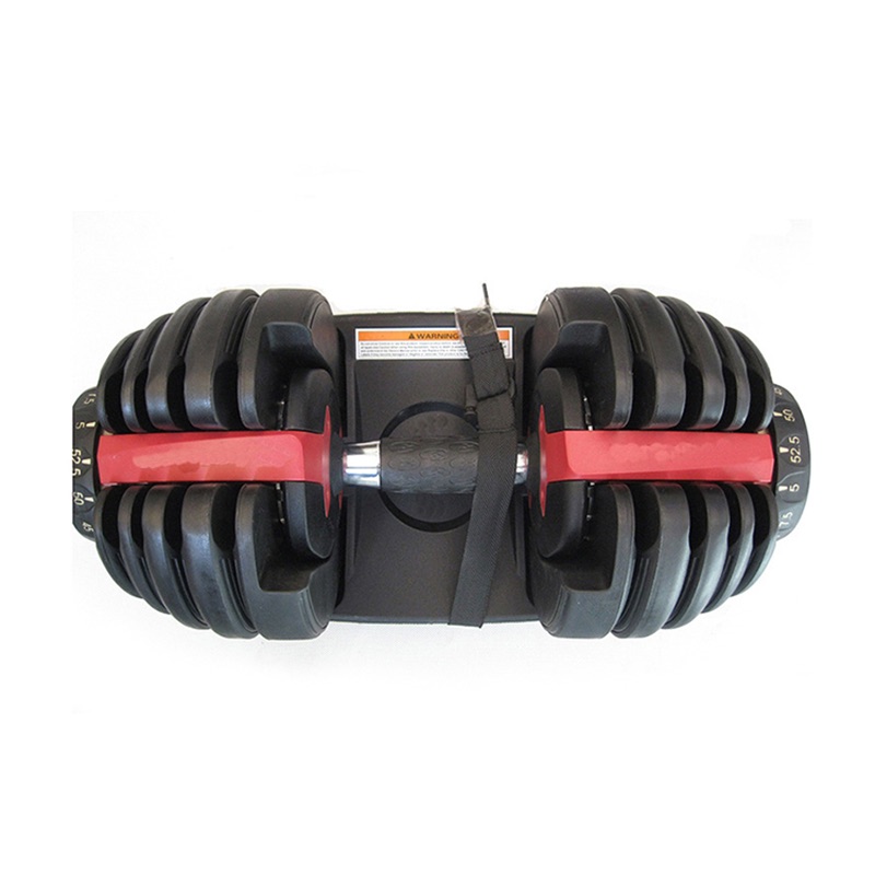An adjustable dumbbell with a black and red handle, resting on a holding tray. The dumbbell has several weight plates attached on both sides and numbers indicating weight increments.